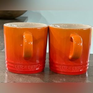 2 Volcanic orange Le Creuset mugs.